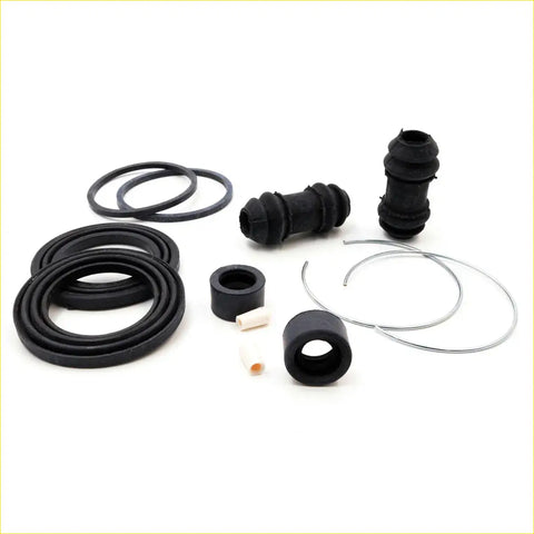 Black rubber and metal disc brake seal kit components for mazda b2000 b2200 b2600 bravo 1985-1998 shown here
