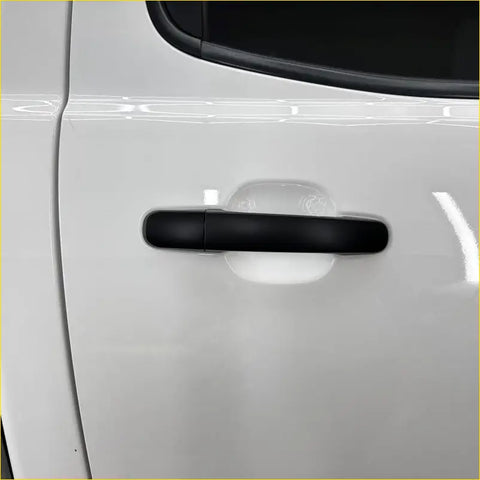 Black matte-finish door handle cover for white mazda bt-50 2012-2020 smart key vehicle visible from the back side
