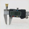 Black digital caliper with silver jaws measuring brass door hinge pin for Toyota Hilux mk3 1978-1997