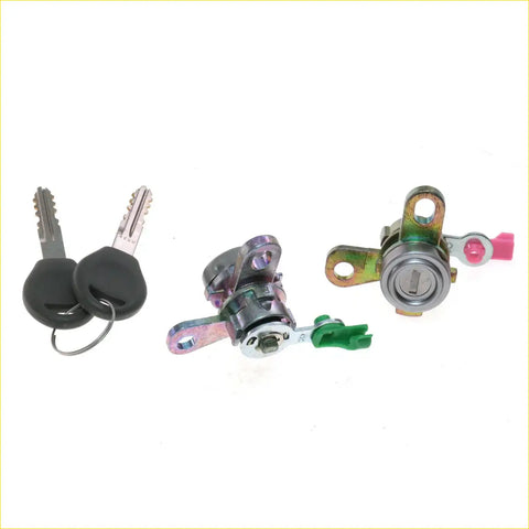 Two car door lock cylinders with green and pink plastic levers and matching keys for nissan caravan urvan e25 estate isuzu como