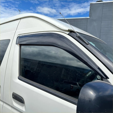 Black carbon fiber style door visor on white toyota hiace van from 2005 to 2019 for weather protection