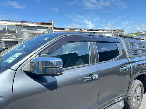 Gray metallic mitsubishi triton 2024 door visors with chrome side mirrors and black roof rack for weather protection