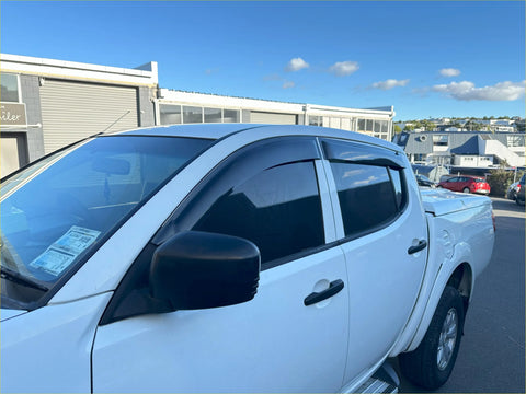 White mitsubishi triton pickup truck with black side mirrors and door visors window monsoons weather shields