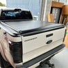 Black electric roller shutter tonneau cover on back of white ford ranger px1 px2 px3 pickup truck