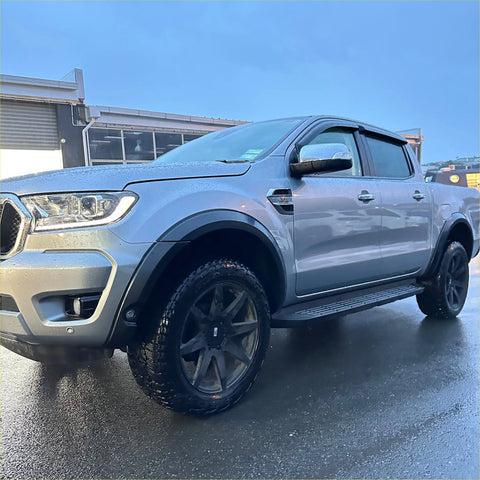 Silver ford ranger px3 2019-2021 with smooth 4-inch fender flare black wheels and side steps shown from back side