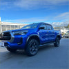Vibrant blue toyota hilux 2021-2024 with matte black 4-inch fender flare and black alloy wheels rugged design