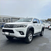 White toyota hilux revo 2015-2017 with black lychee texture bolt style fender flare and roof rack side view