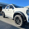 White ford ranger 2022 with matte smooth style wildtrak fender flares black wheels and side steps visible from side