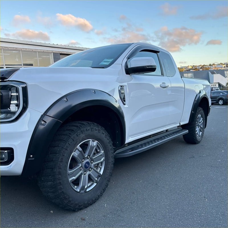White ford ranger 2022+ with matte black bolt style fender flares and silver alloy wheels on new ranger xlt sport