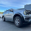 Silver ford ranger 2022 with matte black sport smooth style fender flares and rugged black tires shown from front side