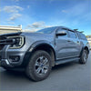 Gray ford ranger 2022+ with matte black sport smooth style double fender flares and rugged tires shown from back side