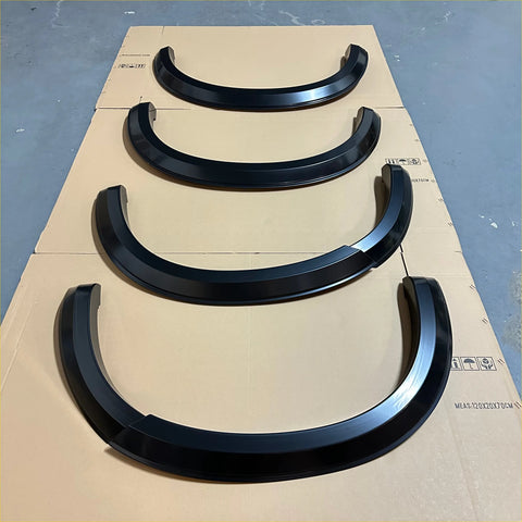 Black glossy finish fender flare set for isuzu d-max 2016-2020 smooth style matte black arranged on cardboard