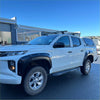 White mitsubishi triton 2019-2023 with matte black bolt style fender flares and roof rack shown from the side