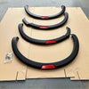 Black fender flares with red accent strips for nissan navara 2021 plus matte black oem style automotive customization