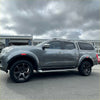 Gray metallic nissan navara pickup with black alloys and hardtop canopy featuring red layer fender flare oem style