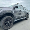 Dark gray metallic toyota hilux with black wheels and sas cruiser decals featuring grey layer fender flares 2021-2024 sr sr5 oem style