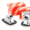 Gray plastic fender guard repeater light assemblies with black rubber gaskets in genuine toyota hilux boxes