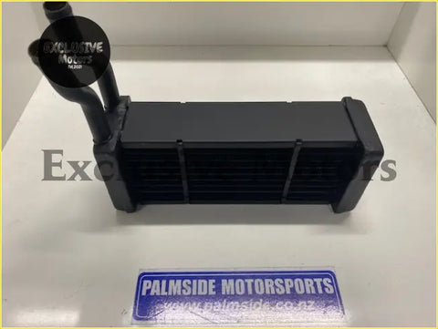 Black ford escort MK1 heater core with rectangular core and two cylindrical inlets made of durable metal or plastic