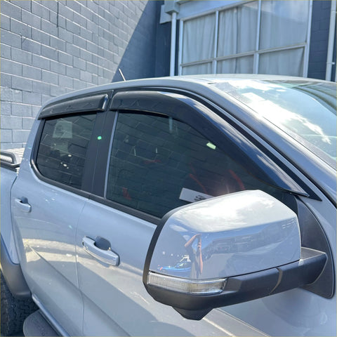 Black plastic door visors installed on a silver ford ranger 2022+ for weather shield protection