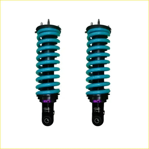 A pair of vibrant teal dobinsons ims monotube coil-over shocks with black mounts and purple accents for ford ranger px3