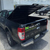 Back view of black ford ranger pickup with lifted tailgate and custom decals featuring tomahawk aluminium hardlid