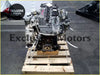 Silver metallic ford ranger weat engine with black parts wrapped in plastic on wooden pallet resting on backside