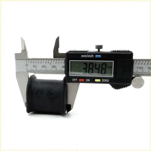 Black rubber bushing from fr stabilizer shaft bush set for toyota hilux 1983-1997 being measured with digital caliper
