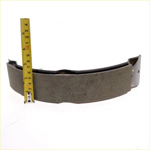 Front brake shoe kit for toyota hilux 2008-2016 dark gray textured curved with metal backing visible on back side