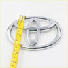 Chrome finished toyota front grill badge with glossy reflective surface and iconic three oval design for hilux vigo 2004 2012