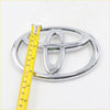 Chrome-finished front grill badge for toyota hilux mk6 sr5 2004-2012 with sleek oval design and three interlocking ovals