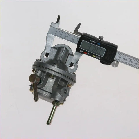 Gray metallic carburetor measured with digital caliper in fuel pump assembly for nissan datsun sunny b210
