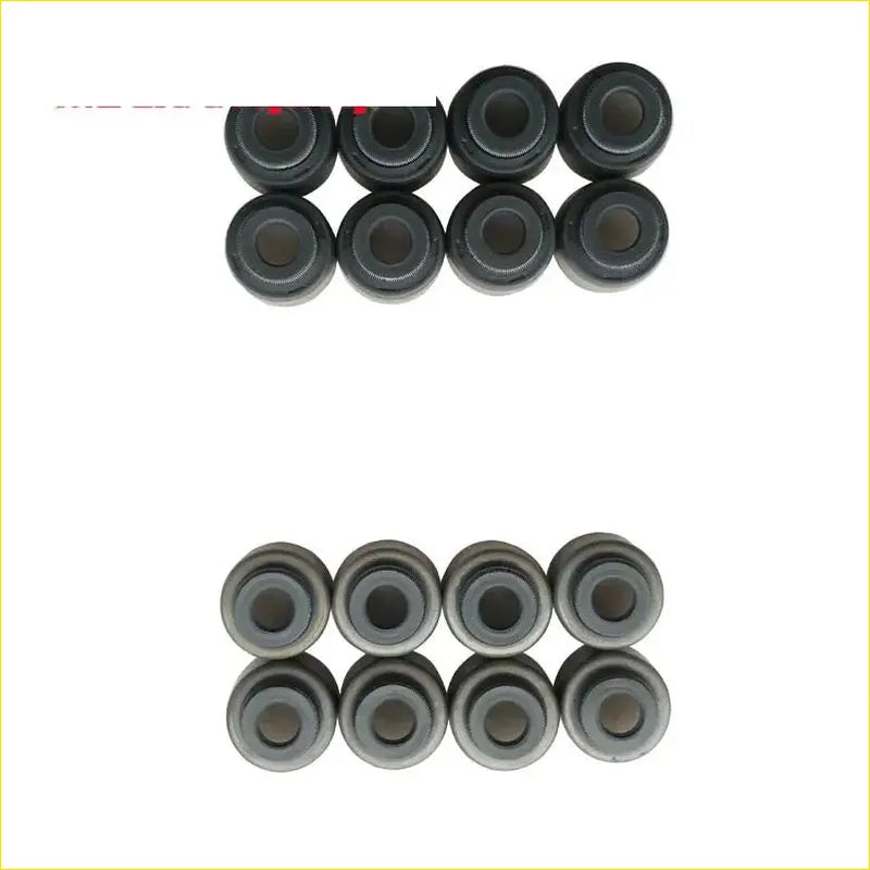 Black rubber and metallic gray valve stem oil seal bushings arranged in two rows for toyota tercel gasket pro set