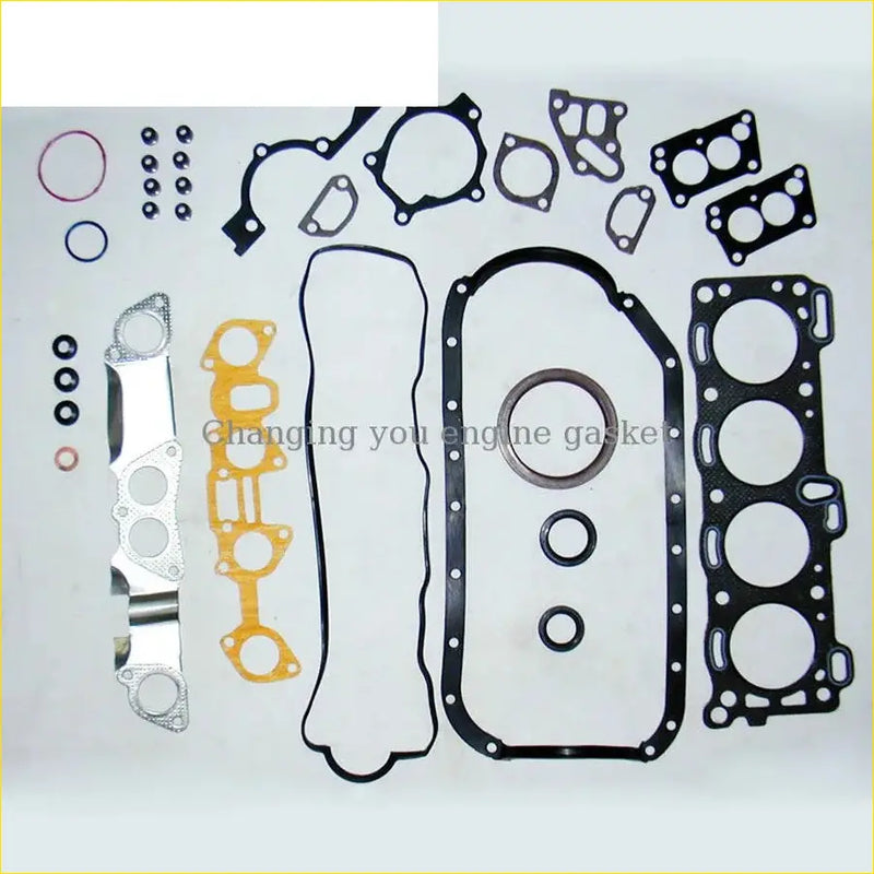 Neatly arranged black yellow and silver gasket pro 4za1 full set for isuzu fargo tfr tfs 1.6l engine on white surface