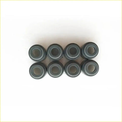 Eight dark gray cylindrical rubber gaskets arranged in two rows for mitsubishi pajero montero 4d56 valve stem oil seal