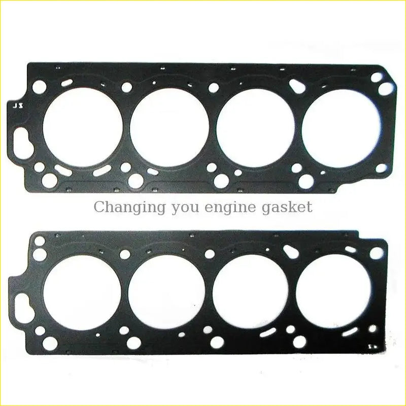 Black metal cylinder head gasket with four circular openings and textured surface for toyota land cruiser 100 or lexus lx 2uzfe