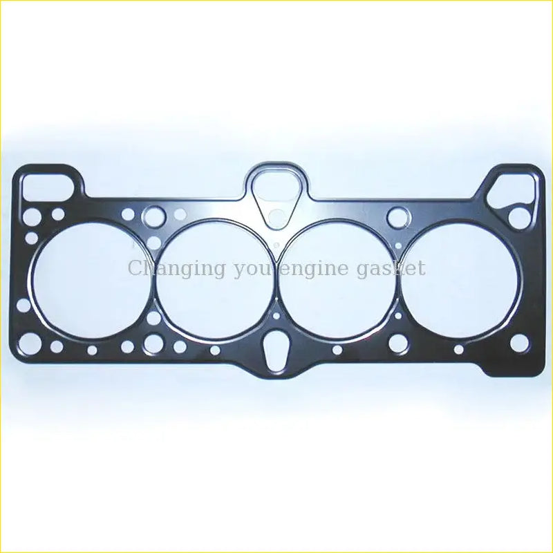 Black metal cylinder head gasket with four circular openings and smaller holes for precise sealing in hyundai 2000 engine