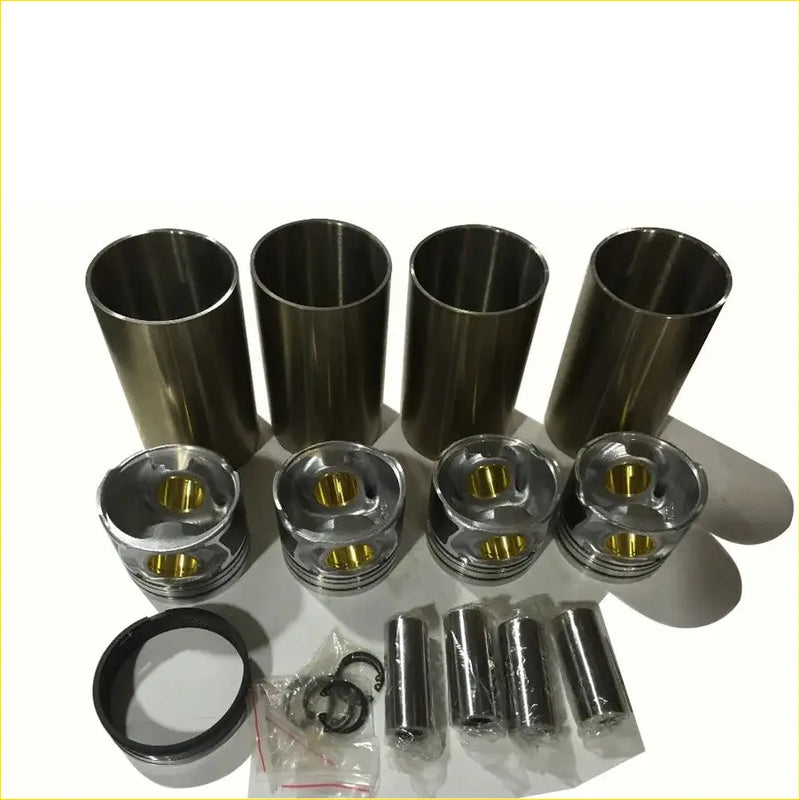 Set of four metallic engine pistons and cylinder liners with gold piston tops for great wall diesel engines