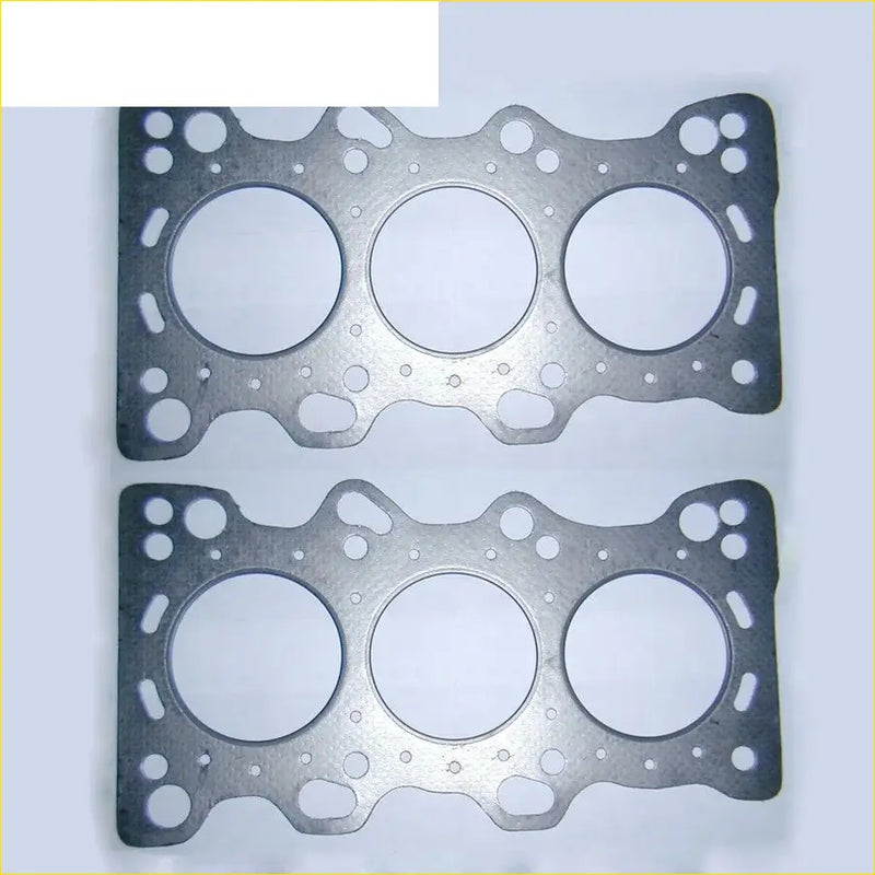 Two silver metallic cylinder head gaskets with three large openings for honda legend and rover 800 engines