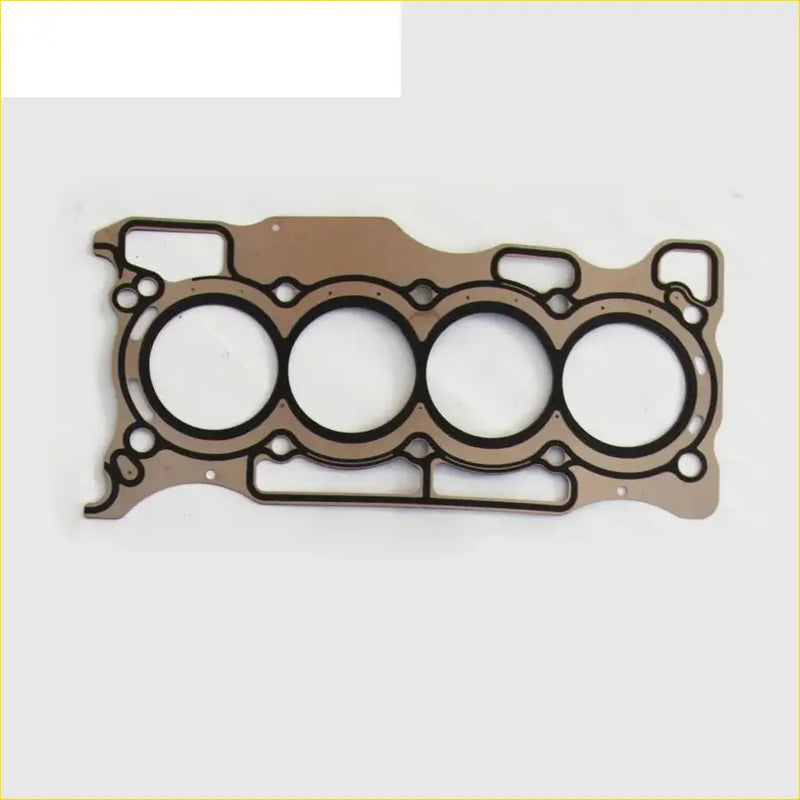 Brown metal cylinder head gasket with four circular openings and black sealing rings for nissan micra tiida versa