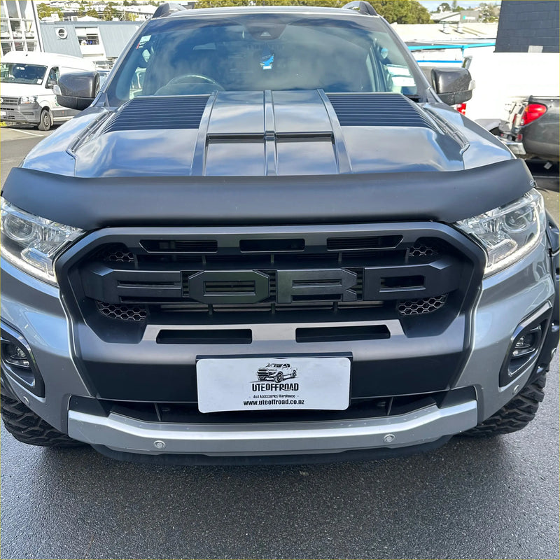 Gray metallic ford ranger with black front grille and hood vents featuring grille for ford ranger px3 wildtrak 2018-2021