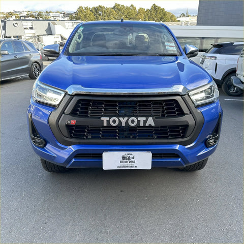 Vibrant blue toyota hilux gr pickup with bold black grille and chrome accents for 2021-2024 sr sr5 models
