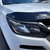 Black glossy plastic hood deflector mounted on white vehicle for headlight and taillight covers holden colorado 2016-2020 matte