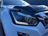 Sleek white isuzu d-max headlight with sharp angular design chrome accents and led lighting for 2016-2020 models