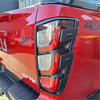 Red isuzu d-max 4x4 taillight with black plastic trim and chrome accents shown from back side with matte black cover
