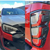 Red and black mitsubishi triton with sleek led headlights and bold taillights featuring matte black headlight and taillight covers
