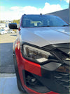 Red and silver two-tone isuzu d-max 2024 pickup with matte black headlight and taillight covers and black accents