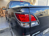 Backside view of black mitsubishi triton with glossy finish and matte headlight and taillight covers for mazda bt-50 2012-2020