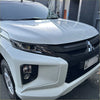 White mitsubishi triton pickup with glossy finish and black grille showing headlight and taillight covers 2019-2023