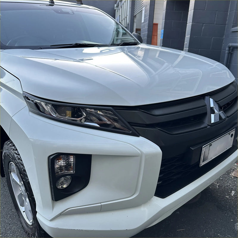 White mitsubishi triton pickup with glossy finish and black grille showing headlight and taillight covers 2019-2023