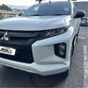 White mitsubishi triton pickup truck with sleek black grille and mirror accents showing headlight and taillight covers